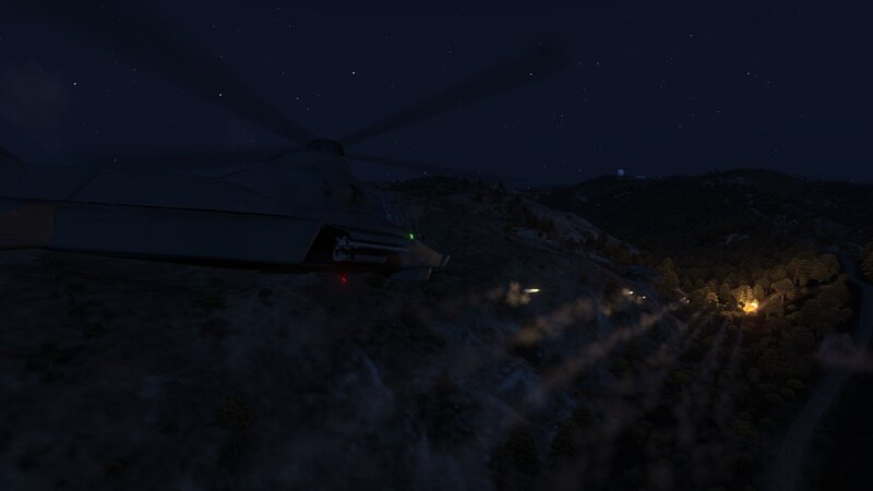 Helicopter at night over hills
