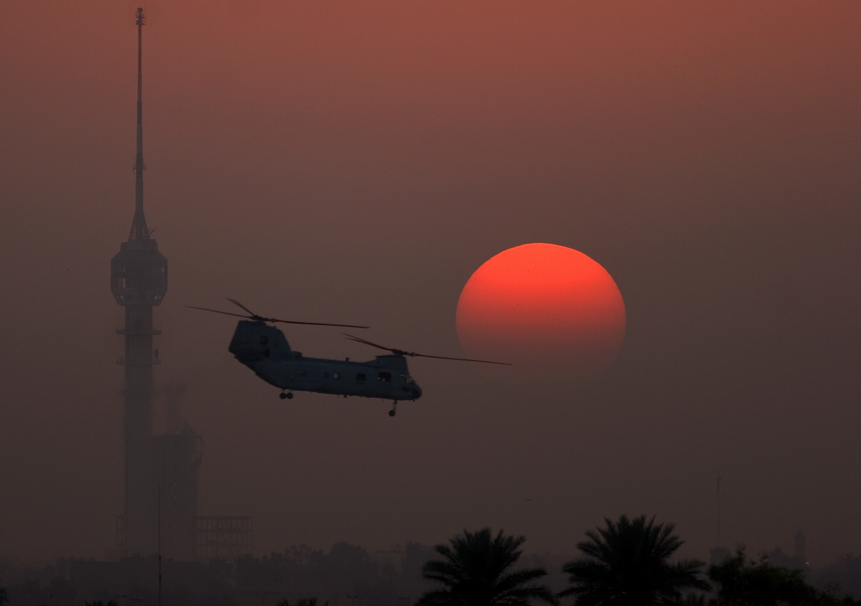 Helicopter at sunset with tower