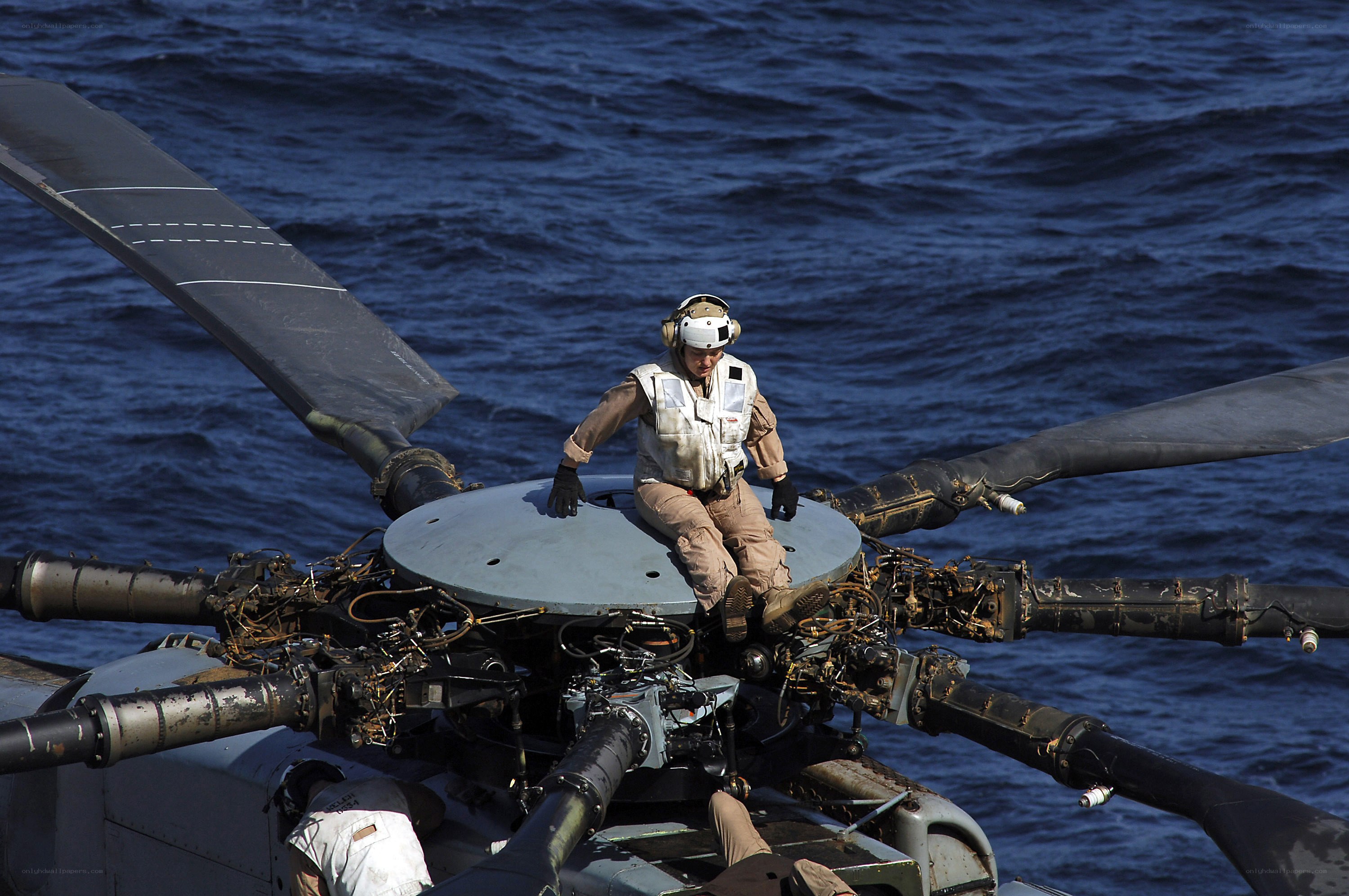 Helicopter crew on rotor