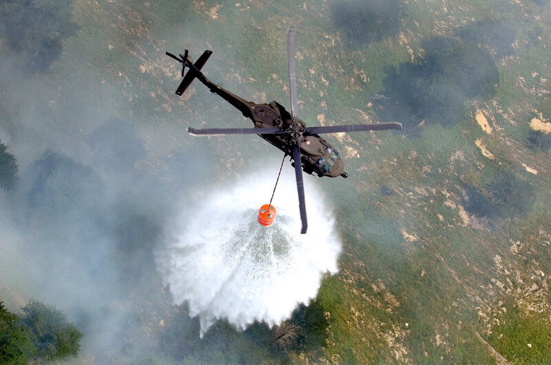 Helicopter drops water on wildfire
