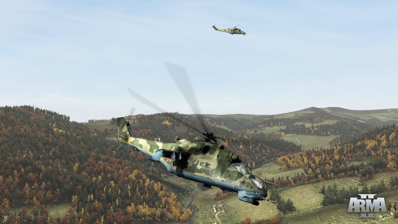 Helicopter flight over forested hills