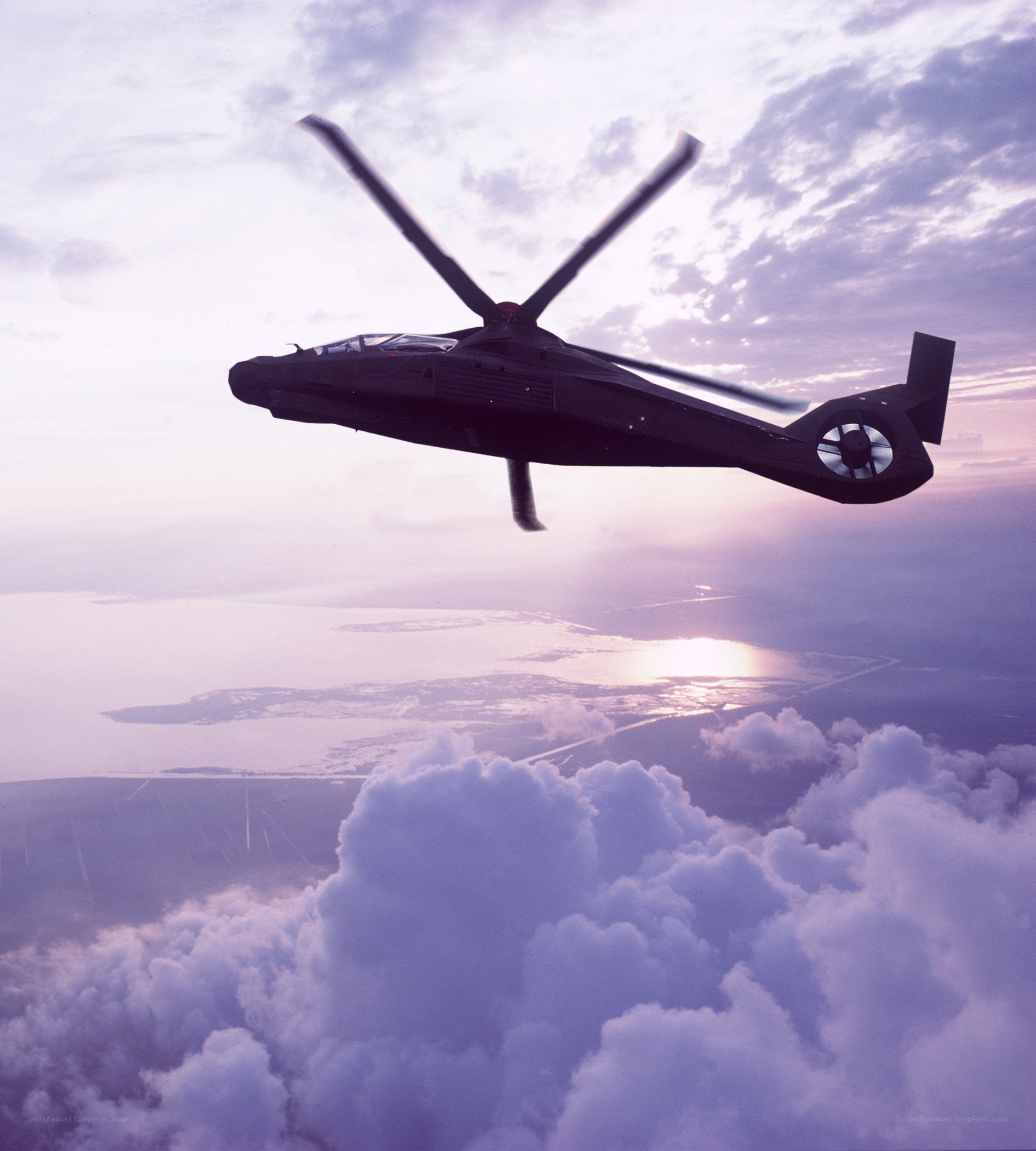 helicopter flying above clouds