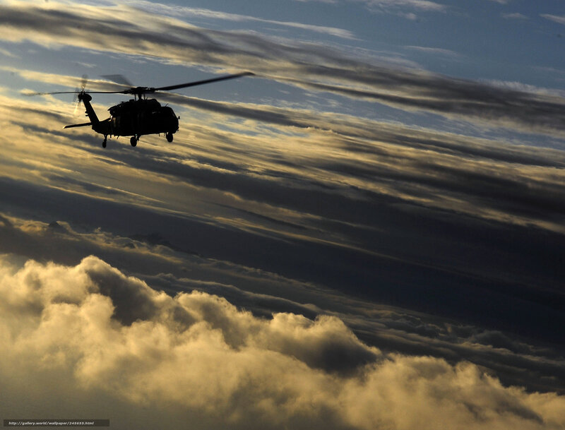 Helicopter flying above clouds