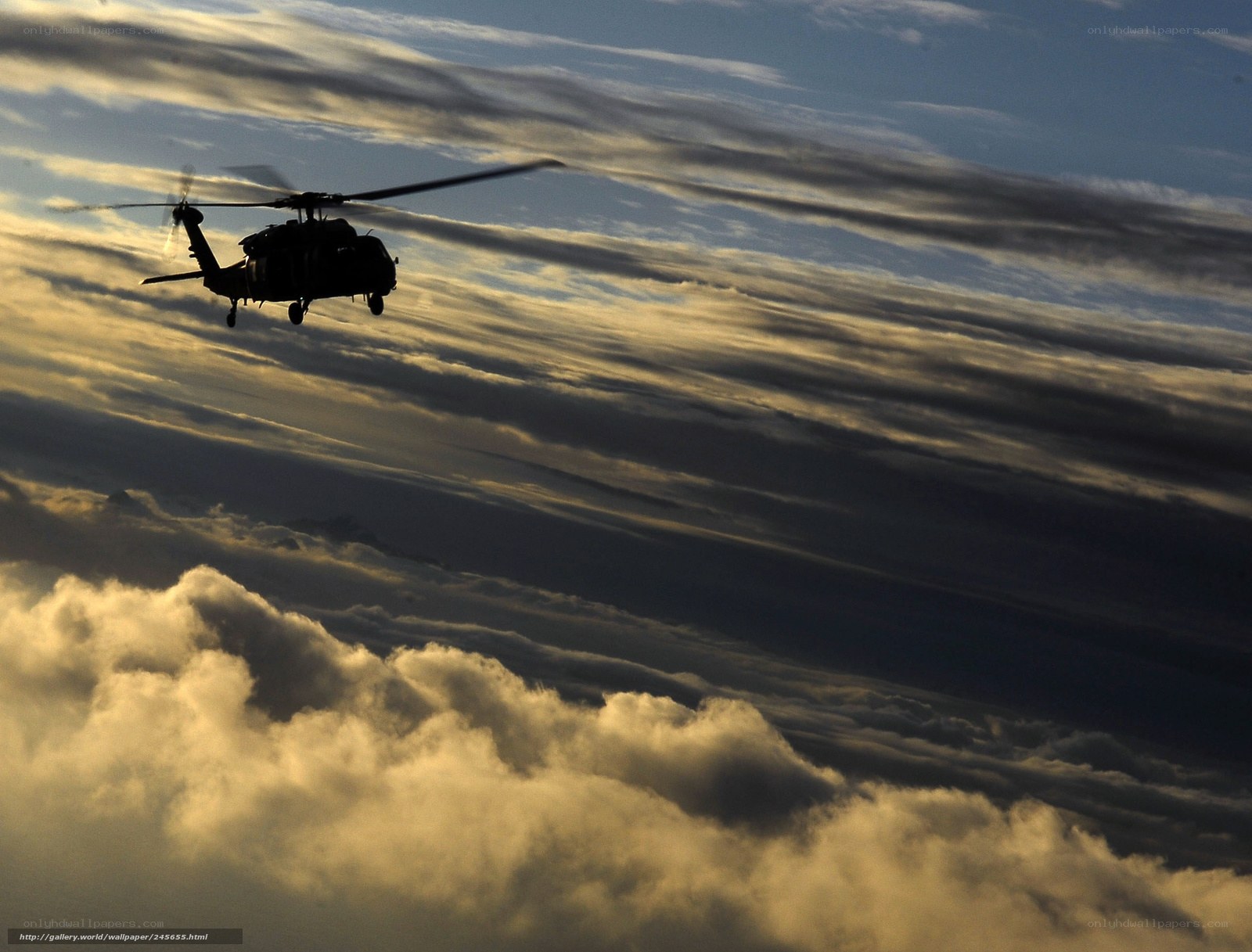 Helicopter flying above clouds