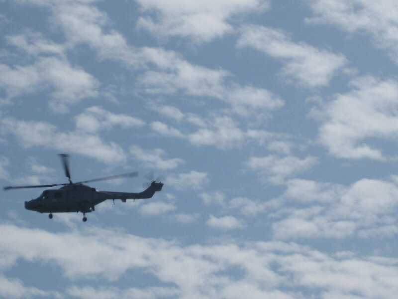 helicopter flying in cloudy sky