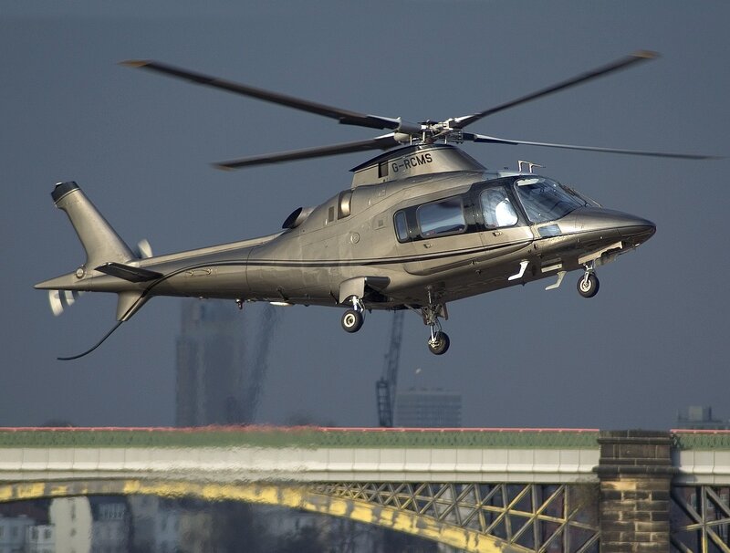 Helicopter flying over bridge