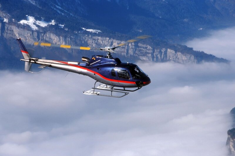 helicopter flying over clouds