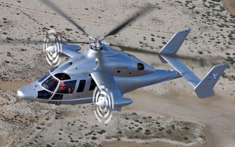 helicopter flying over desert