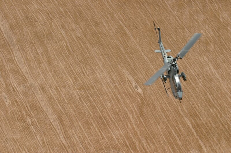 Helicopter flying over field