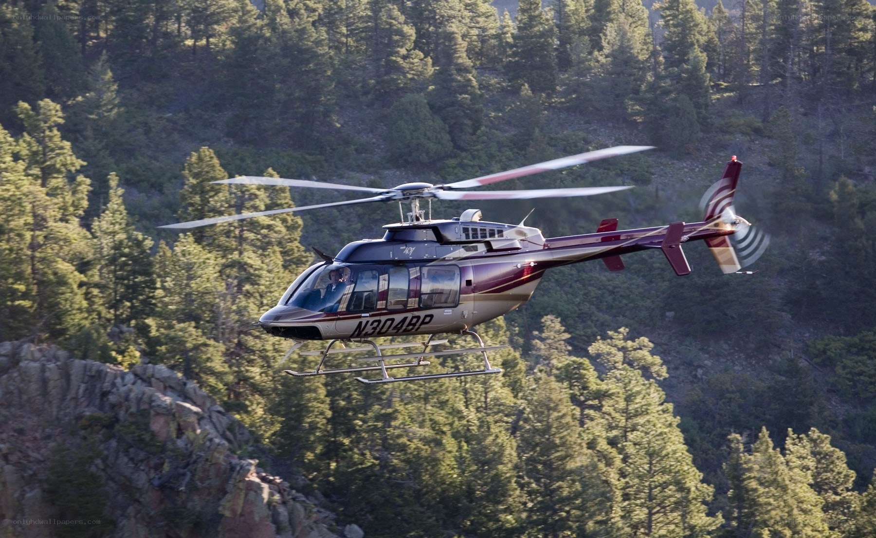 helicopter flying over forest