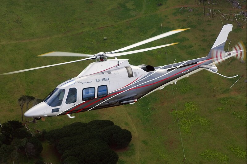 helicopter flying over green field