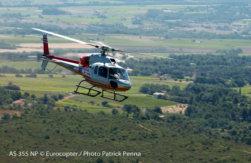 Helicopter flying over green fields