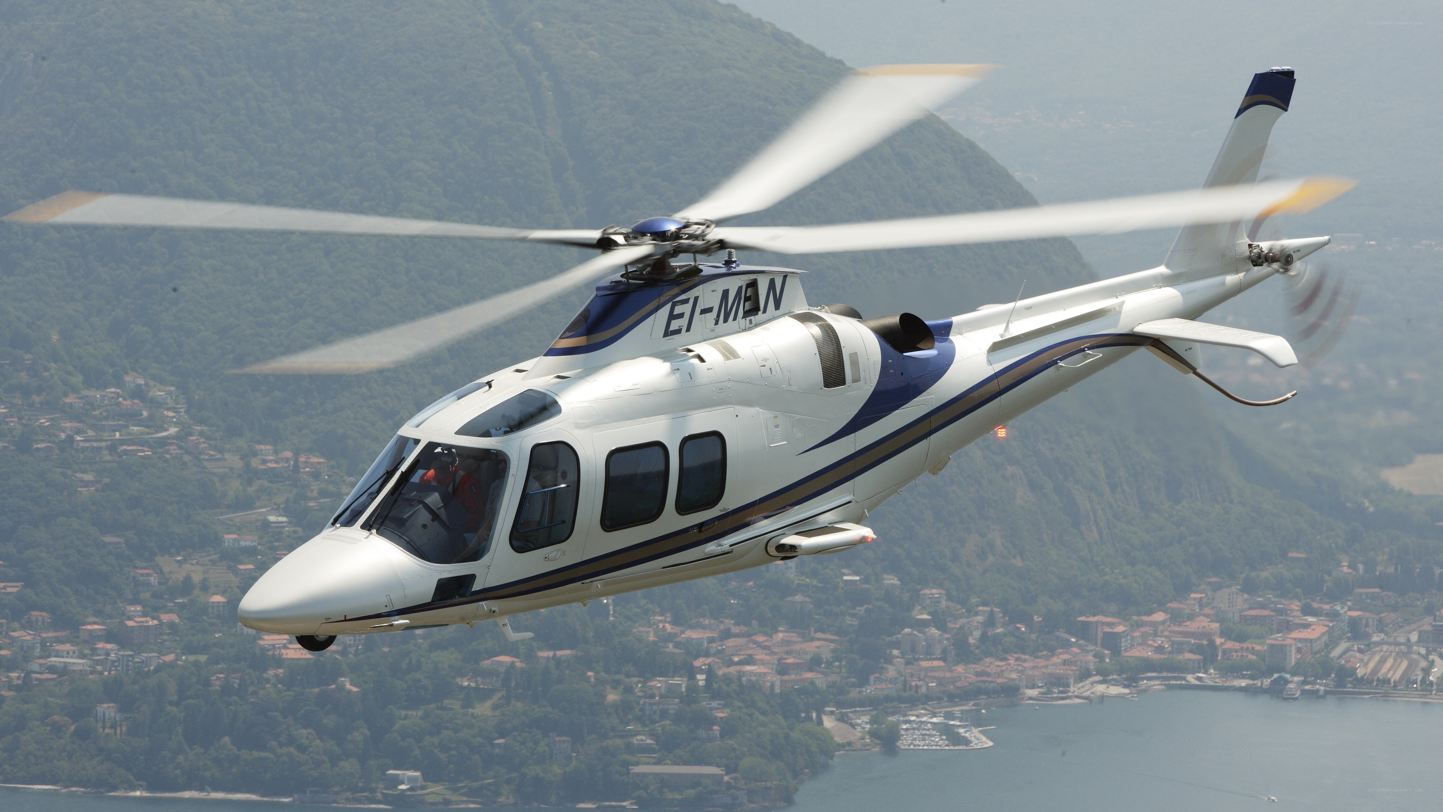helicopter flying over lake