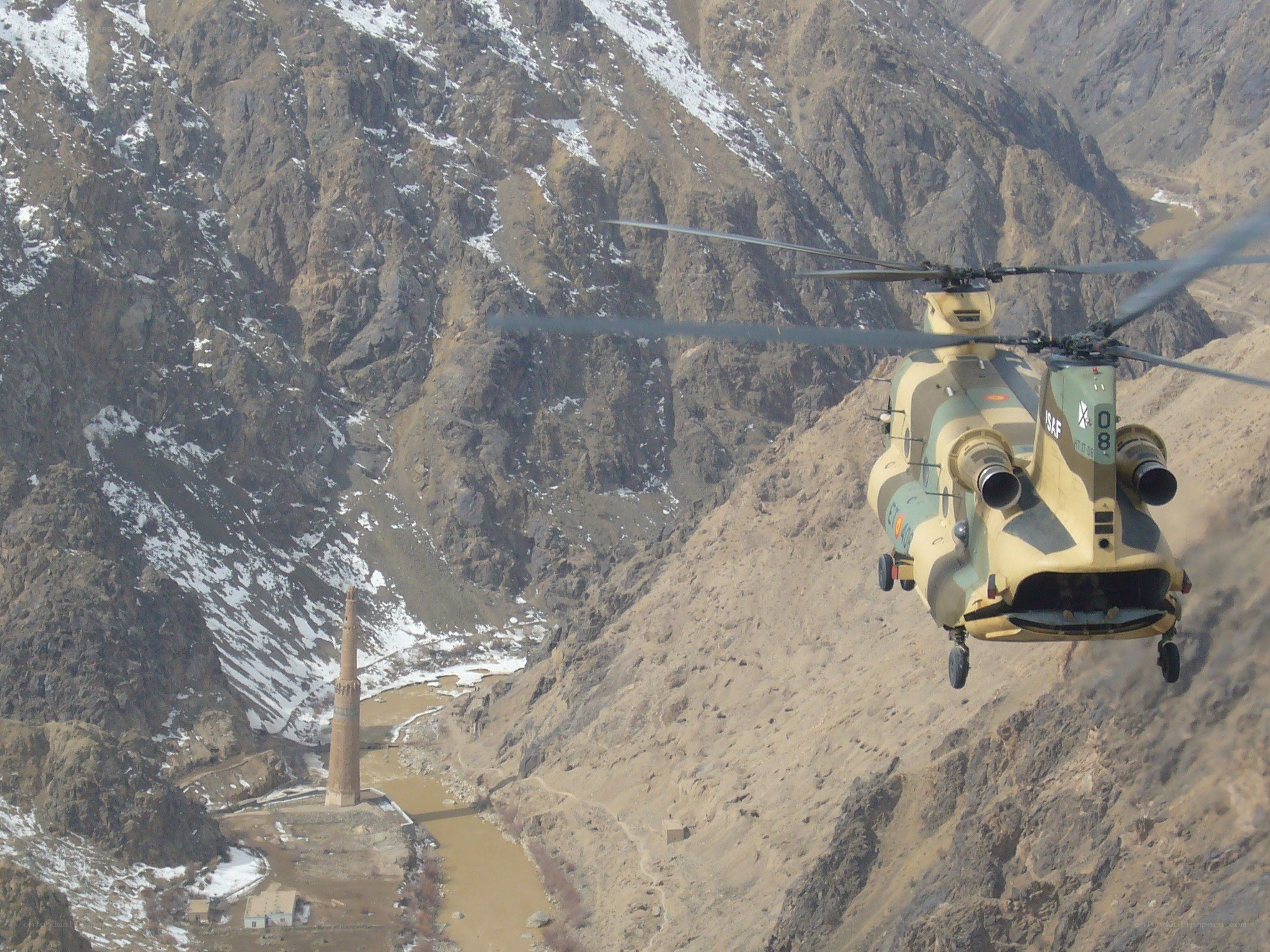 Helicopter flying over mountain valley