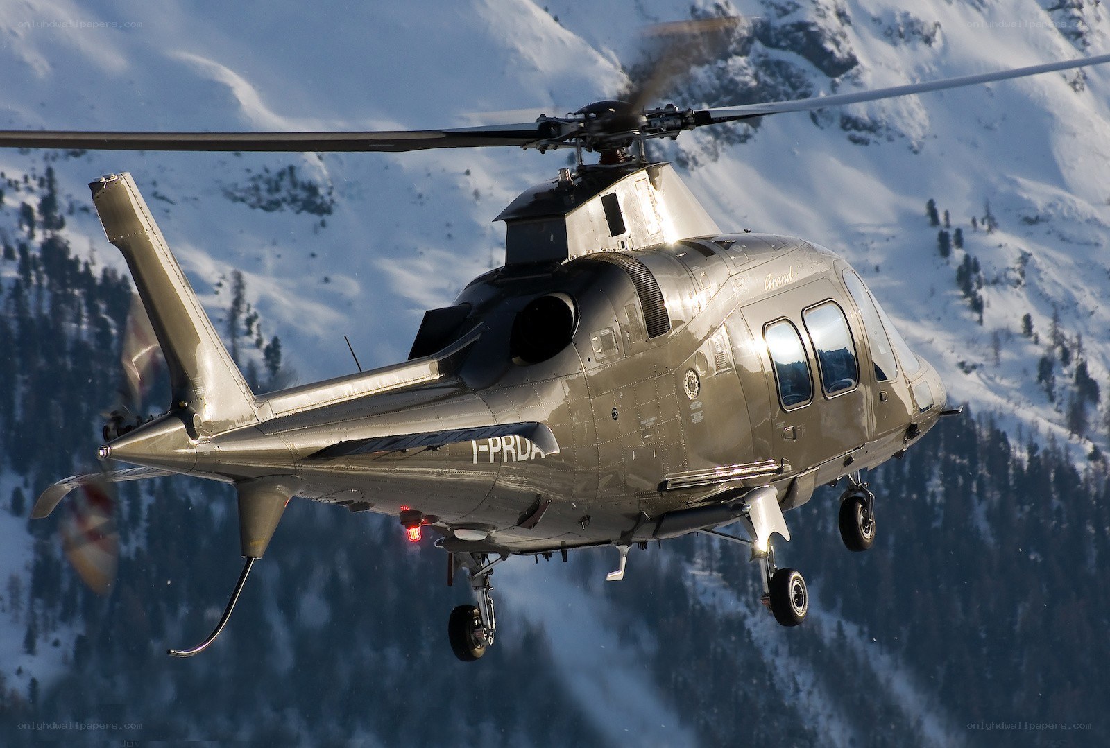 Helicopter flying over snowy mountains
