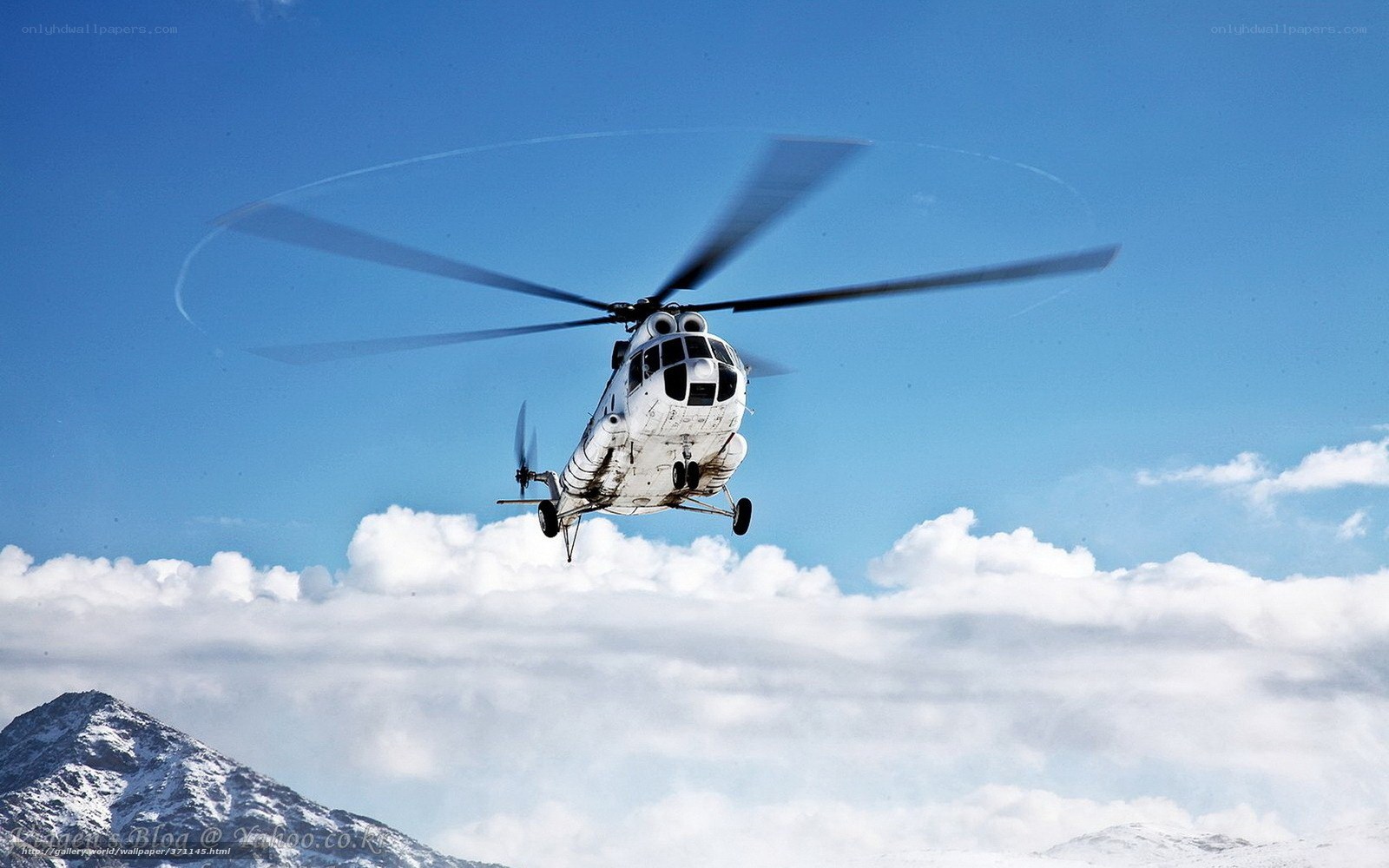 Helicopter flying over snowy mountains