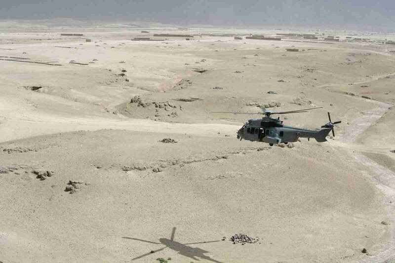 Helicopter in desert terrain