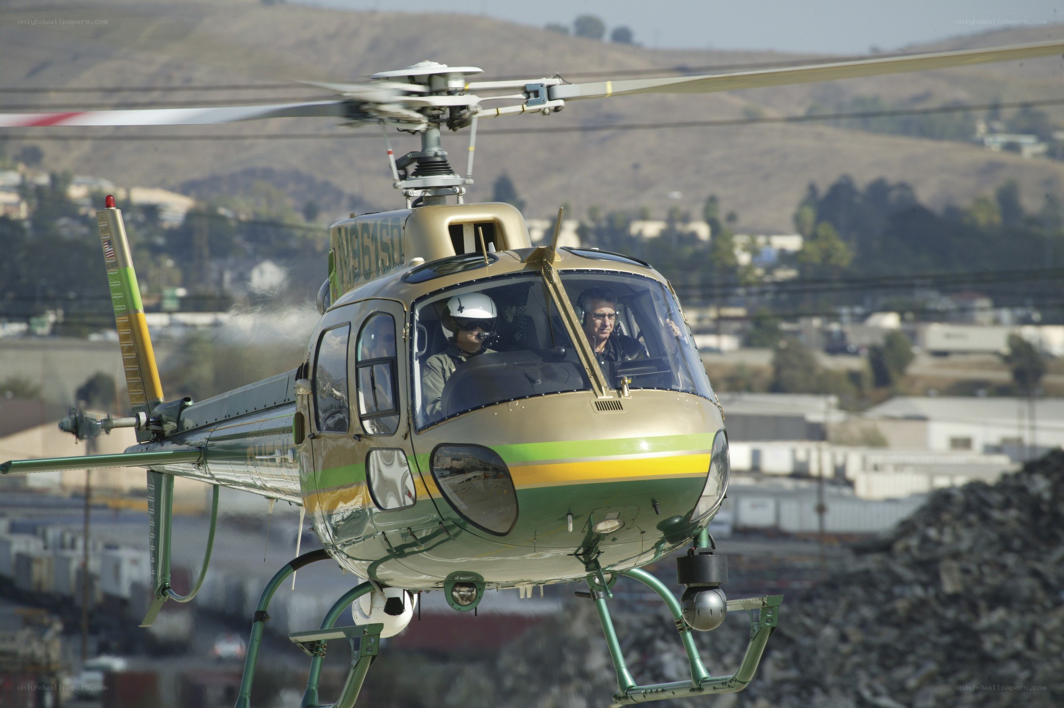 Helicopter in flight over industrial area