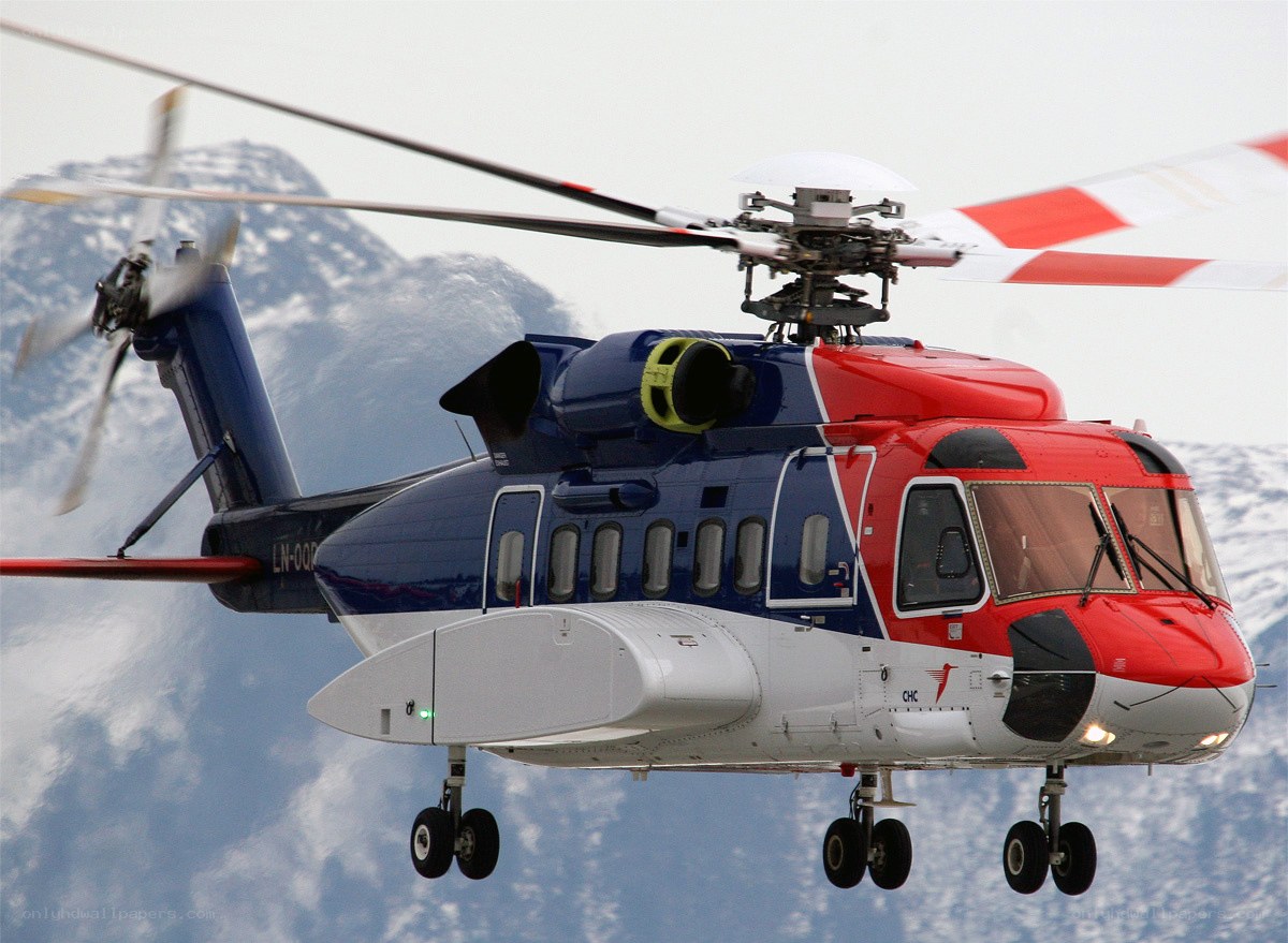 Helicopter in flight over mountains