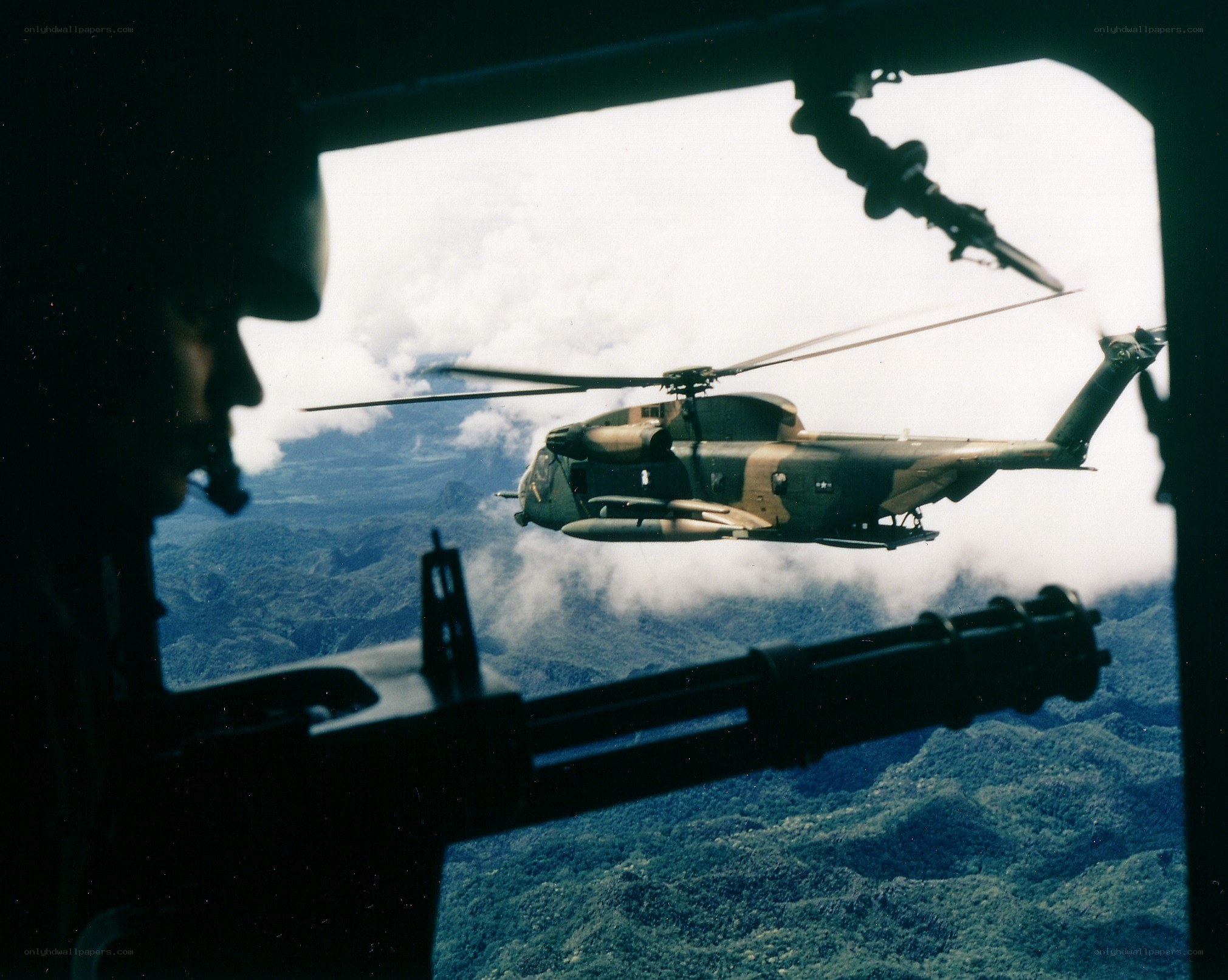 Helicopter in flight over mountains