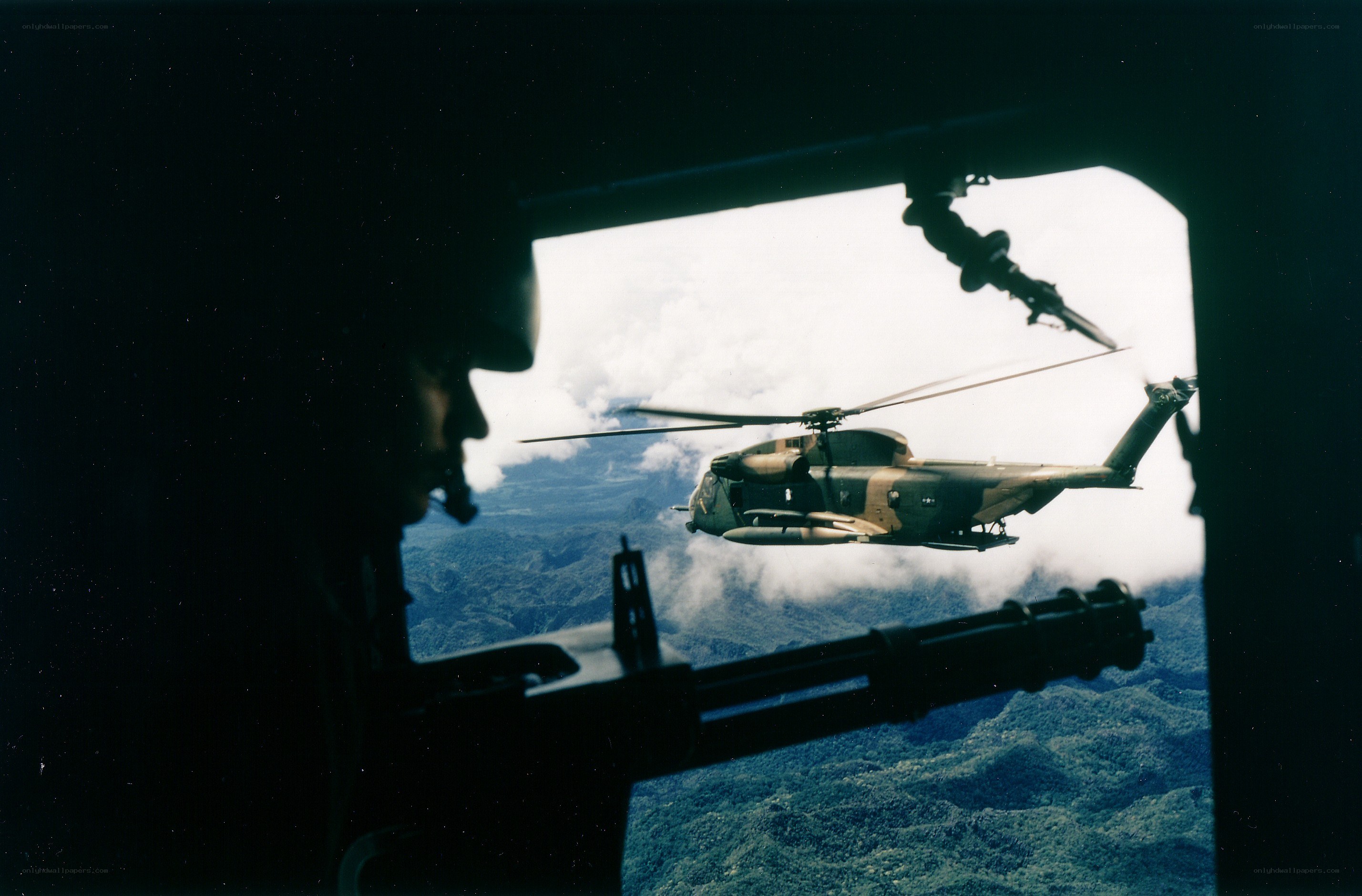 Helicopter in flight over mountains