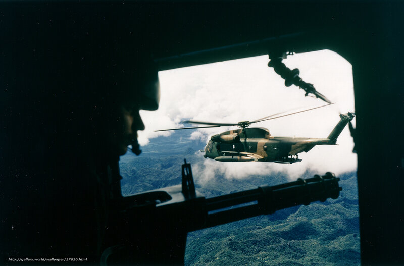 Helicopter in flight over mountains