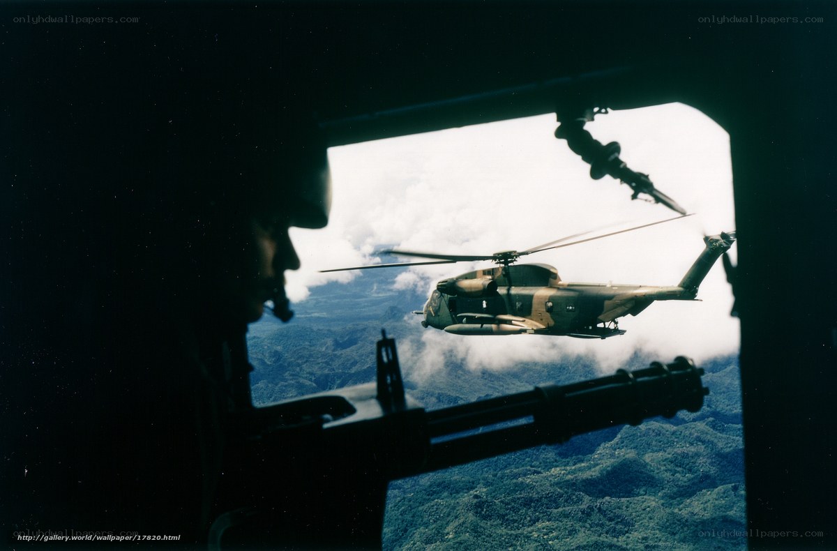 Helicopter in flight over mountains
