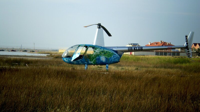 Helicopter in Grass Field