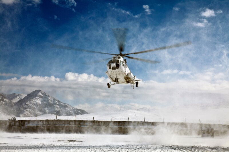 Helicopter landing in snowy mountains
