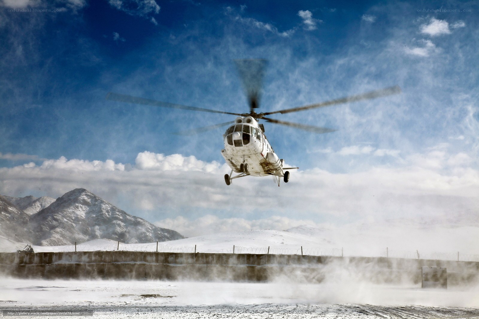 Helicopter landing in snowy mountains