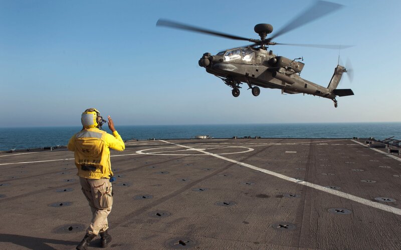 Helicopter landing on aircraft carrier