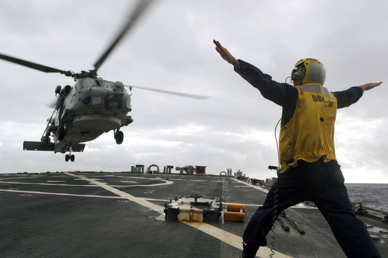 Helicopter landing on aircraft carrier