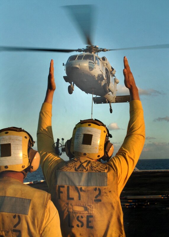 Helicopter landing on aircraft carrier