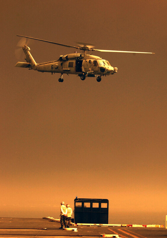 Helicopter landing on aircraft carrier