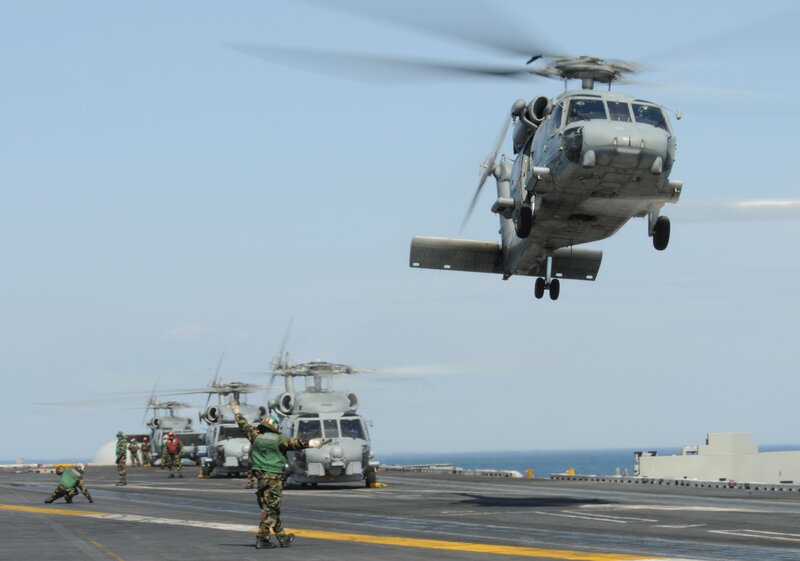 Helicopter landing on aircraft carrier