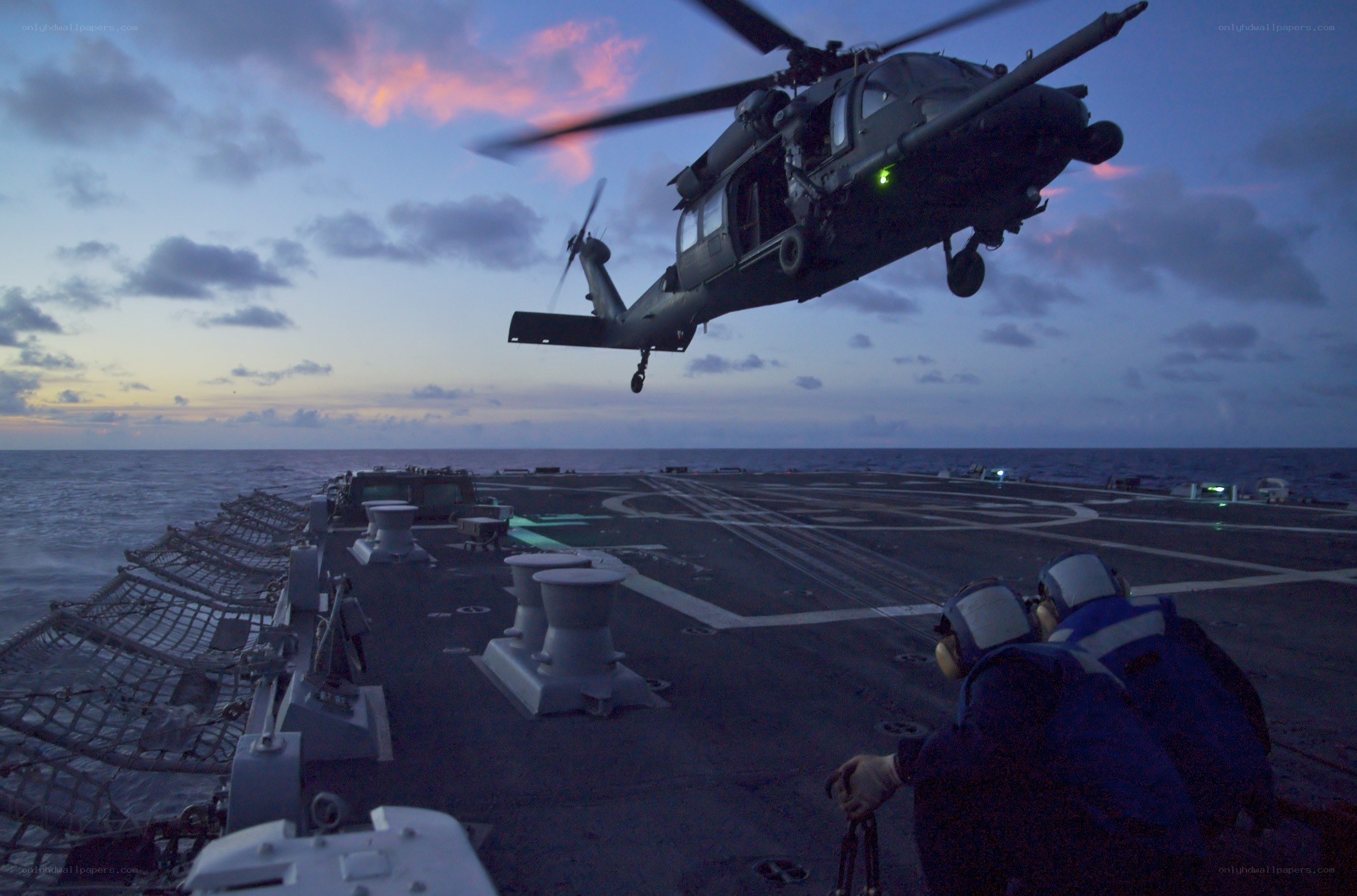 Helicopter landing on ship deck