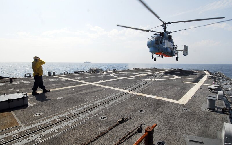 Helicopter landing on ship deck