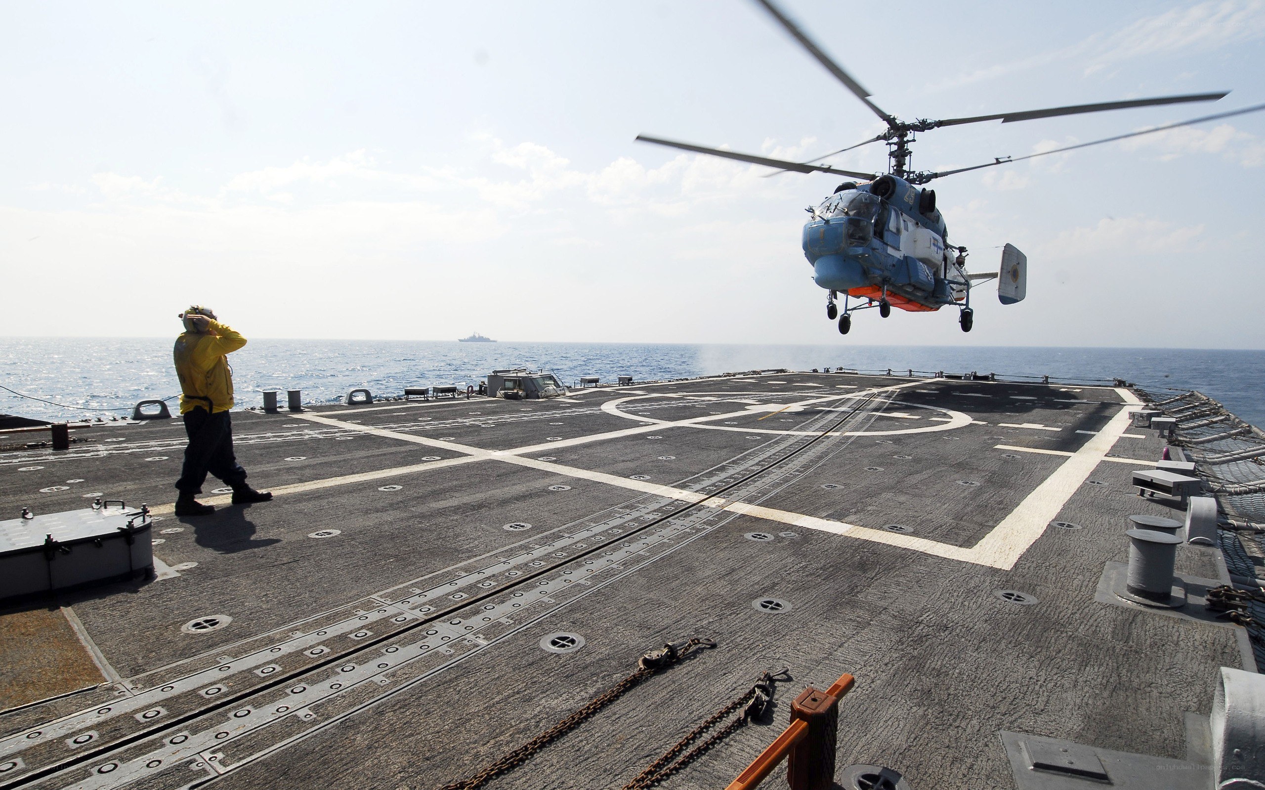 Helicopter landing on ship deck