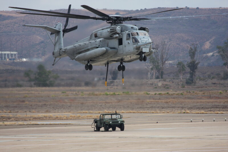 Helicopter lifting military vehicle