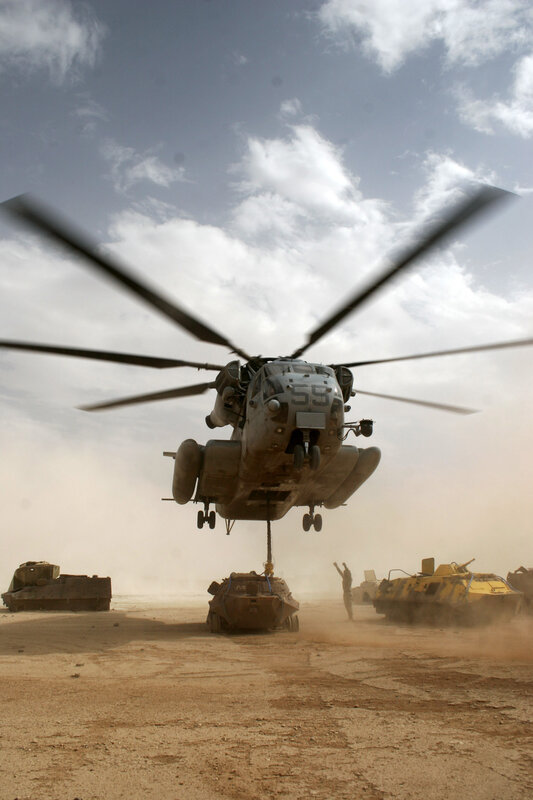 Helicopter lifting military vehicle