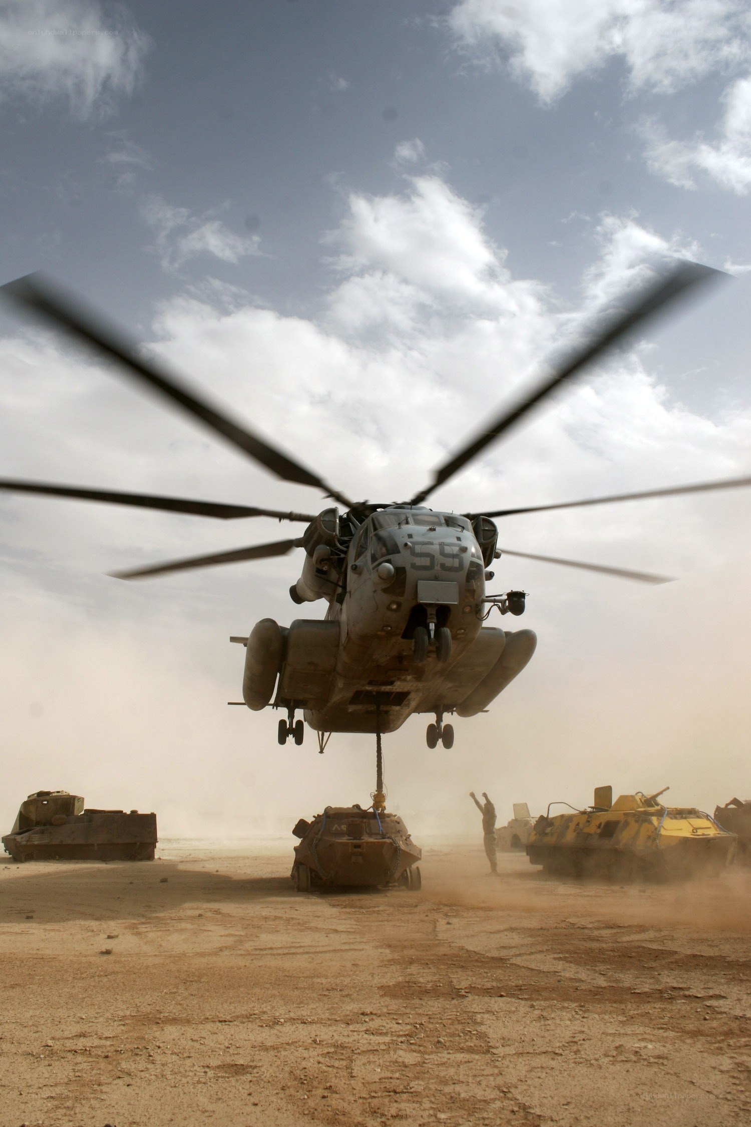 Helicopter lifting military vehicle