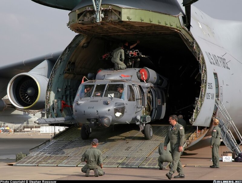 Helicopter loading into cargo plane