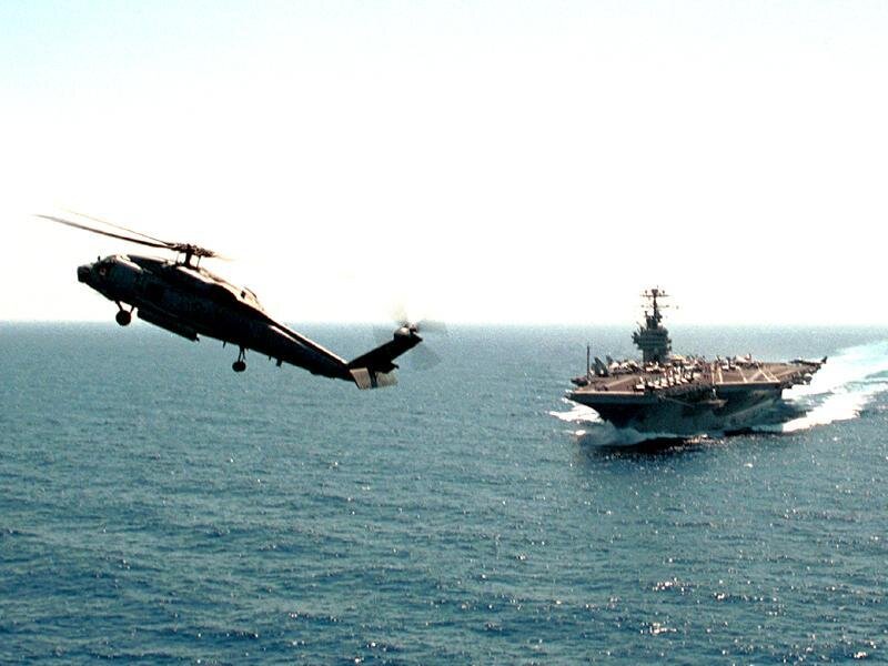 Helicopter Near Aircraft Carrier