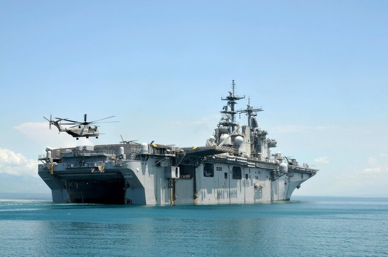 Helicopter near amphibious assault ship