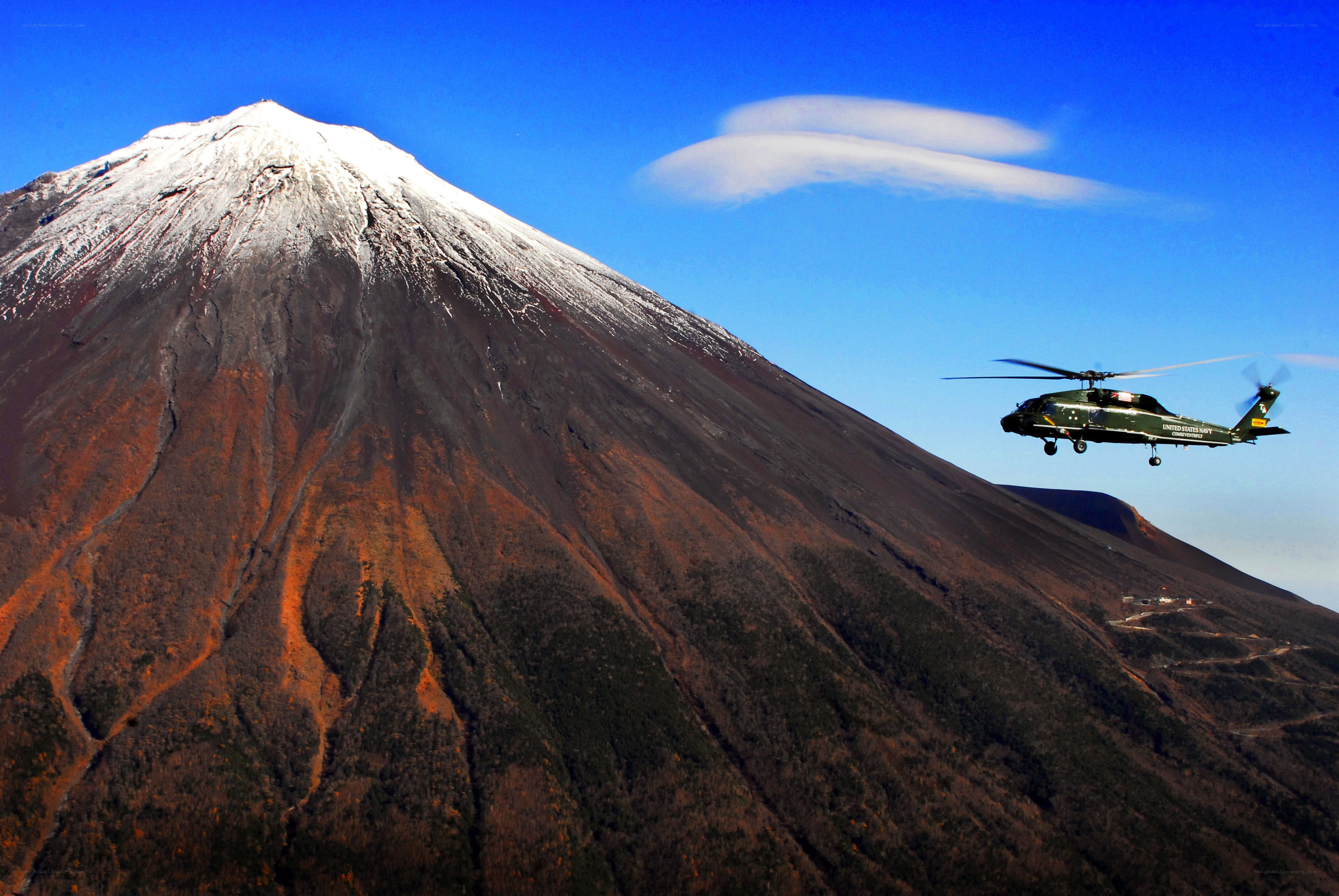 Helicopter near snow-capped mountain