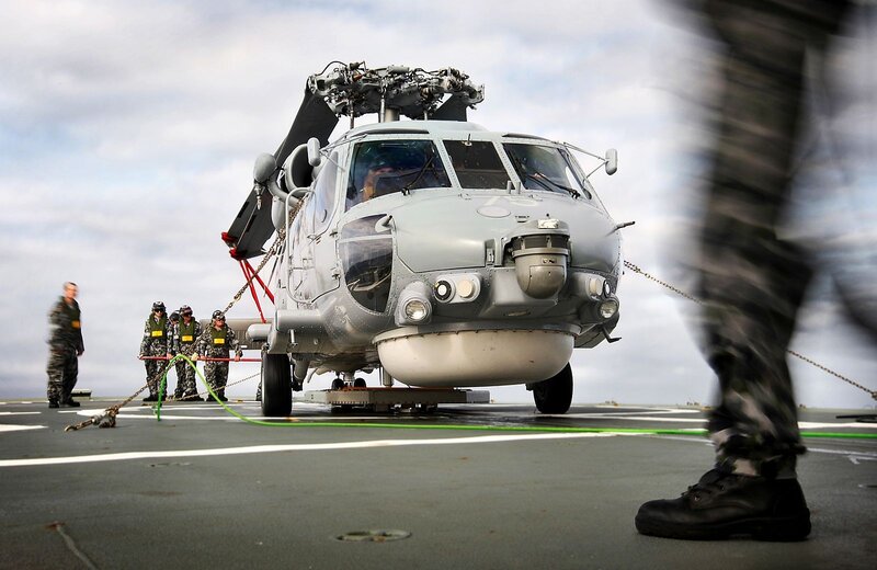 Helicopter on aircraft carrier deck