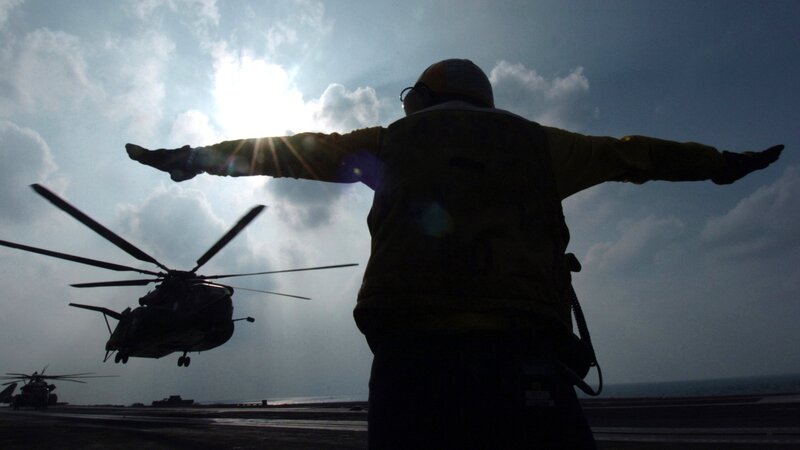 Helicopter on aircraft carrier deck