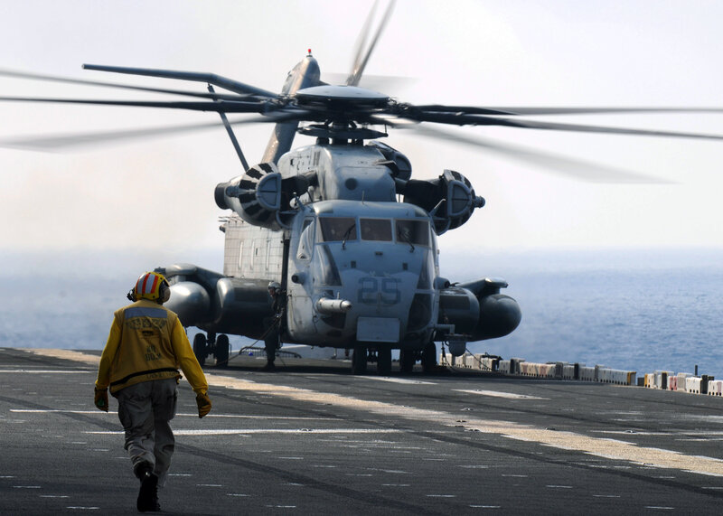 Helicopter on Aircraft Carrier — Gray, Dramatic, Afternoon, Photograph, Person in Uniform