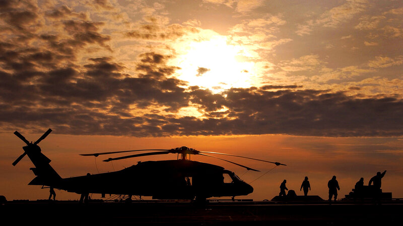Helicopter on deck at sunset