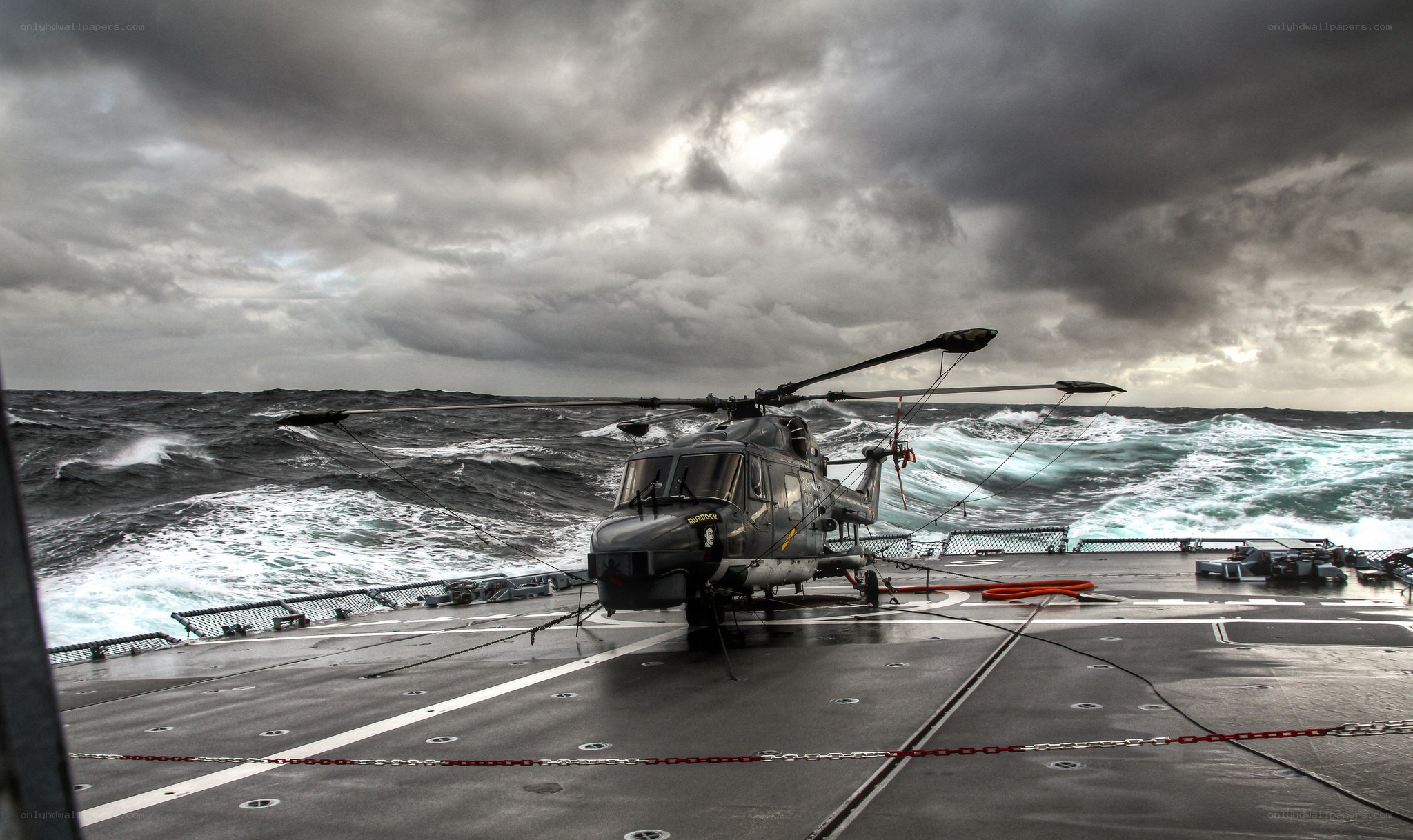 Helicopter on ship in stormy sea